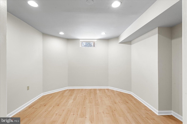 basement with hardwood / wood-style flooring