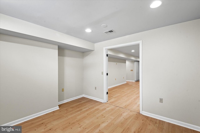 basement with hardwood / wood-style floors