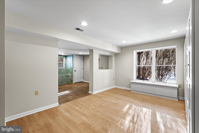 unfurnished room with hardwood / wood-style flooring