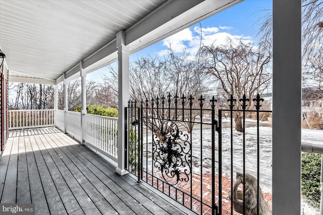 wooden terrace featuring covered porch