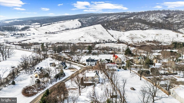 snowy aerial view featuring a mountain view