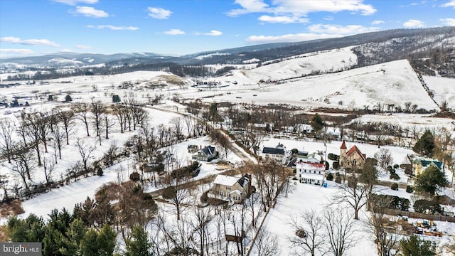 snowy aerial view with a mountain view