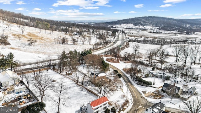 snowy aerial view featuring a mountain view