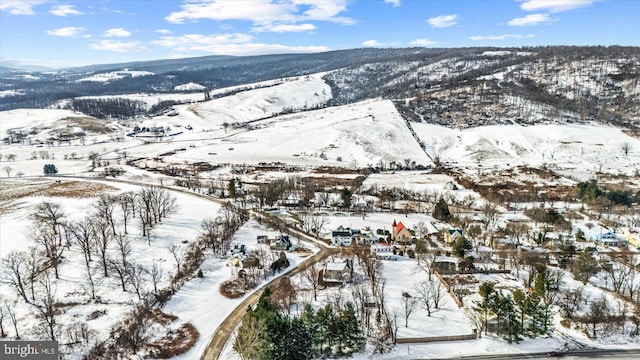 snowy aerial view featuring a mountain view