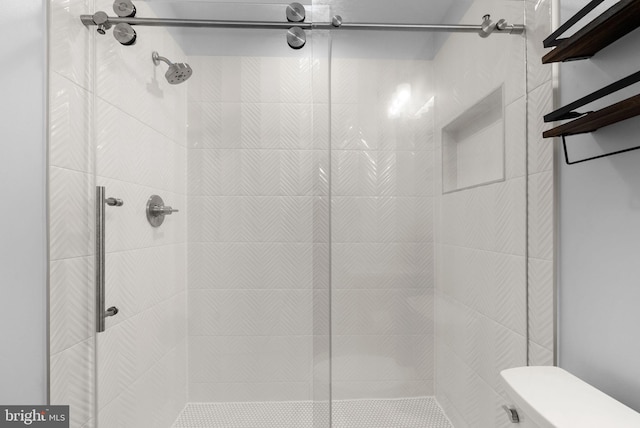 bathroom with tiled shower and toilet