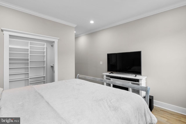 bedroom with light wood-type flooring and ornamental molding