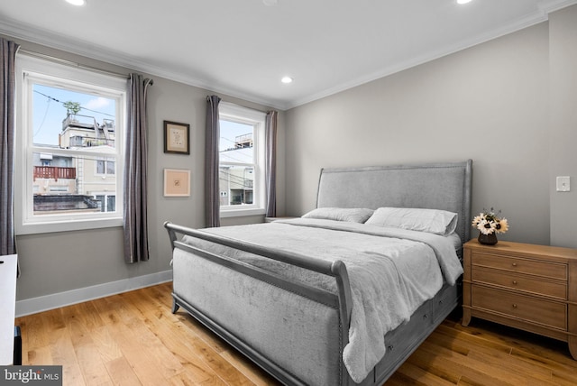 bedroom with crown molding and hardwood / wood-style flooring