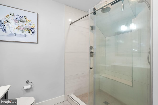 bathroom featuring vanity, toilet, and a shower with shower door