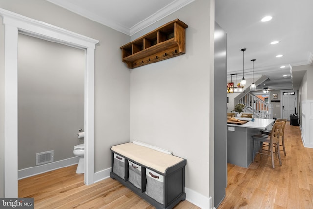 mudroom with ceiling fan, light hardwood / wood-style floors, and ornamental molding