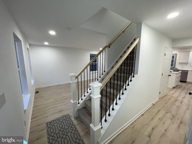 staircase featuring hardwood / wood-style floors