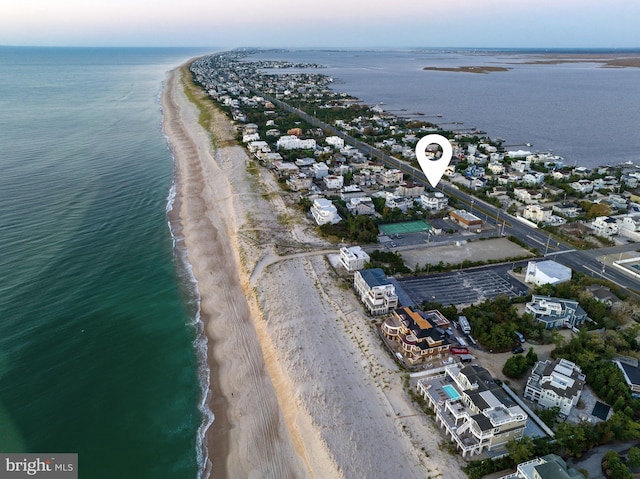 drone / aerial view featuring a water view and a view of the beach