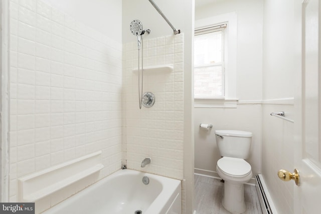 bathroom with toilet, a baseboard radiator, and tiled shower / bath