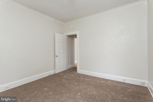 carpeted spare room with crown molding