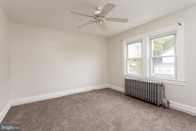 unfurnished room featuring carpet, ceiling fan, and radiator heating unit