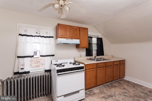 kitchen featuring lofted ceiling, radiator, sink, ceiling fan, and white range with gas stovetop