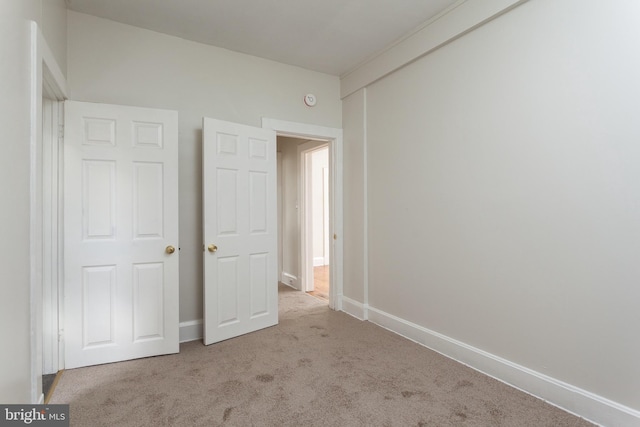 unfurnished bedroom with light carpet