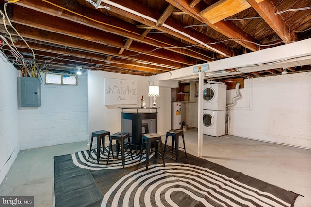 basement featuring electric panel, water heater, and stacked washer and clothes dryer