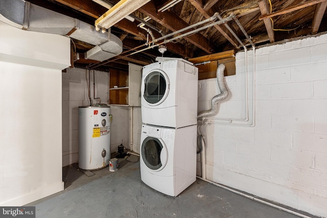 washroom featuring gas water heater and stacked washer / dryer