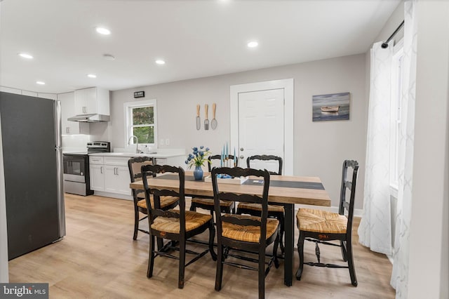 dining area featuring sink and light hardwood / wood-style floors