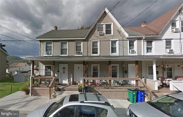 view of front of home with a porch and cooling unit