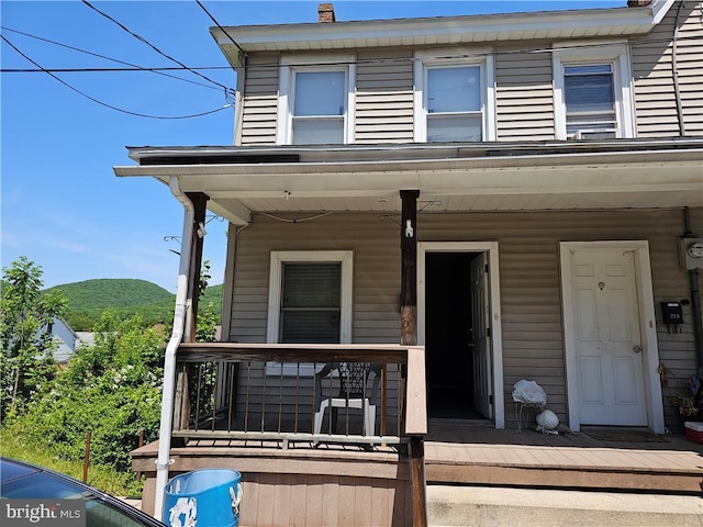 view of front of home featuring a mountain view and covered porch