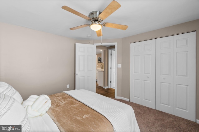 carpeted bedroom featuring ceiling fan, sink, and a closet