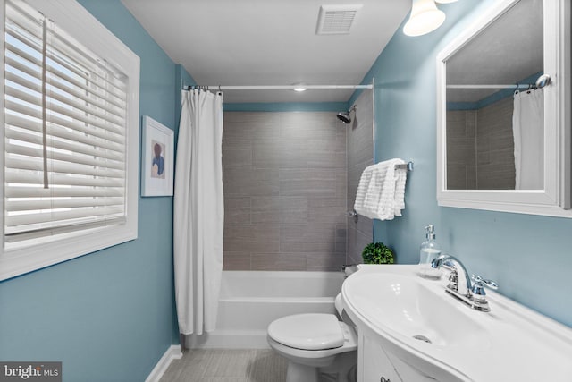 full bathroom with tile patterned flooring, toilet, vanity, and shower / tub combo with curtain