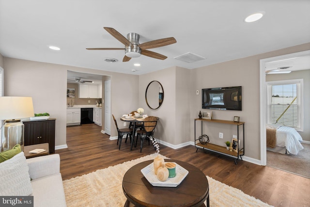 living room featuring ceiling fan and dark hardwood / wood-style floors