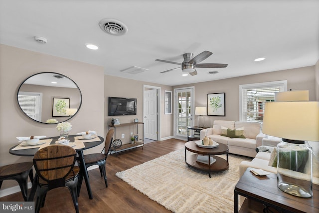 living room featuring ceiling fan and dark hardwood / wood-style floors