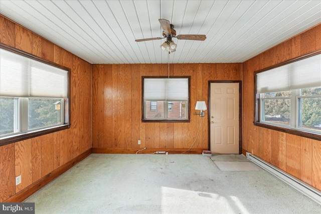 unfurnished sunroom featuring ceiling fan and baseboard heating