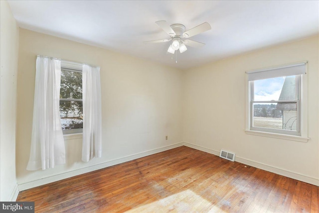 empty room featuring wood-type flooring and ceiling fan