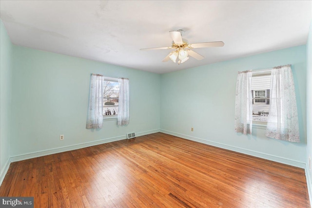 empty room featuring wood-type flooring and ceiling fan