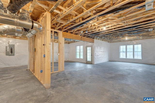 basement featuring electric panel and a wealth of natural light