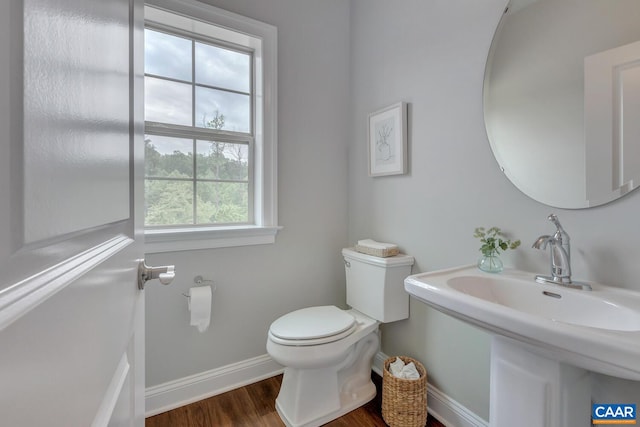 bathroom featuring hardwood / wood-style flooring, toilet, a healthy amount of sunlight, and sink