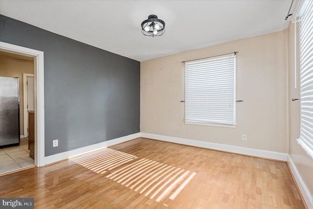 spare room with light wood-type flooring