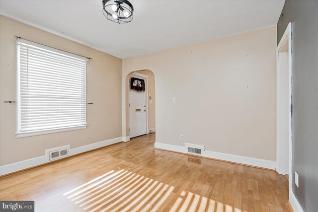 unfurnished room with wood-type flooring