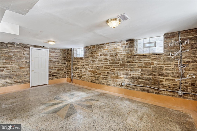 basement with brick wall