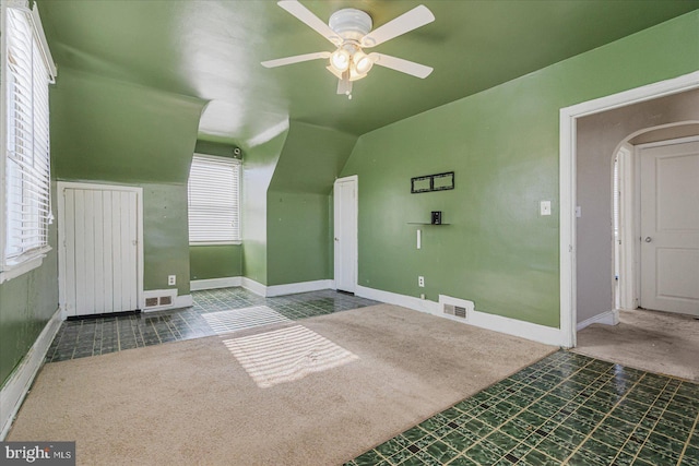 bonus room with ceiling fan, carpet flooring, and vaulted ceiling