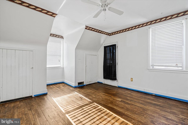 bonus room featuring dark hardwood / wood-style flooring, vaulted ceiling, and ceiling fan