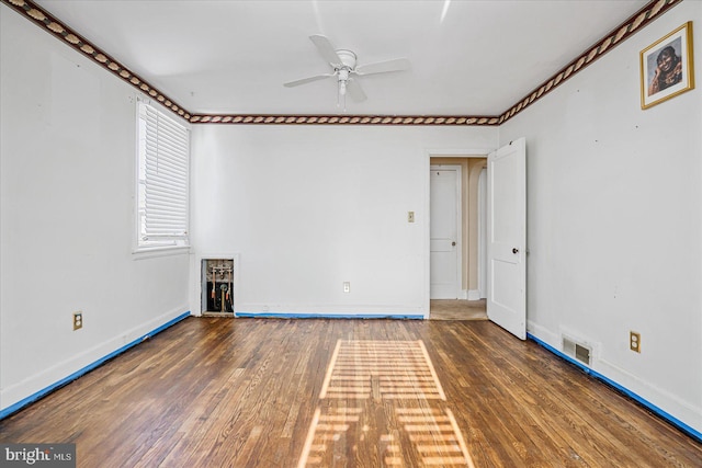 unfurnished room with dark wood-type flooring and ceiling fan