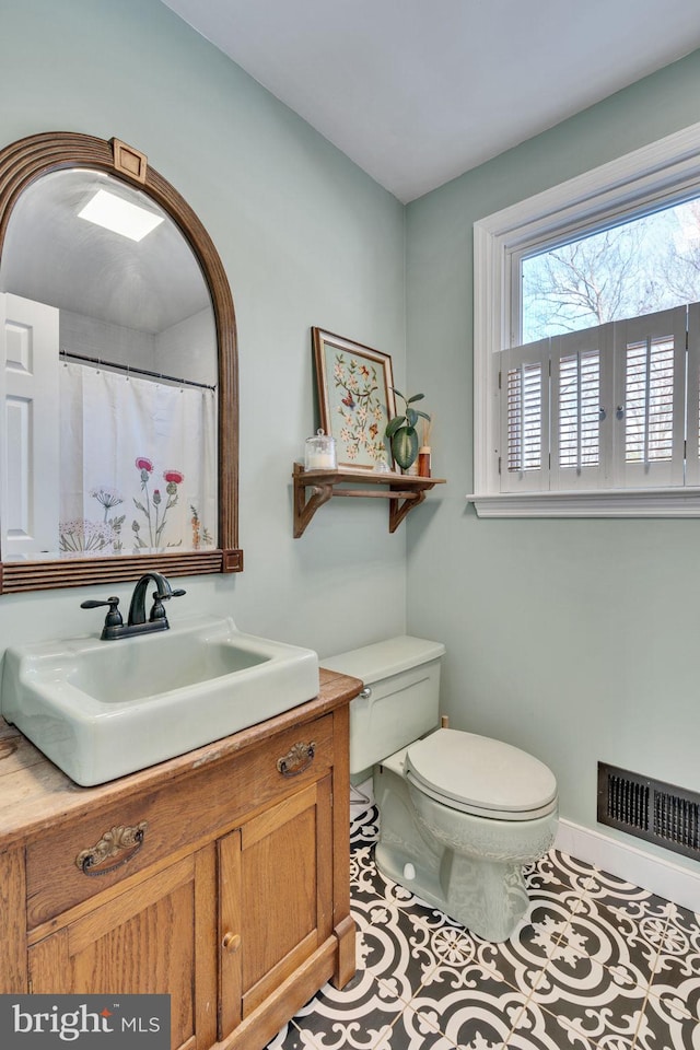 bathroom with vanity, tile patterned floors, and toilet