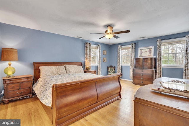 bedroom with light hardwood / wood-style flooring and ceiling fan