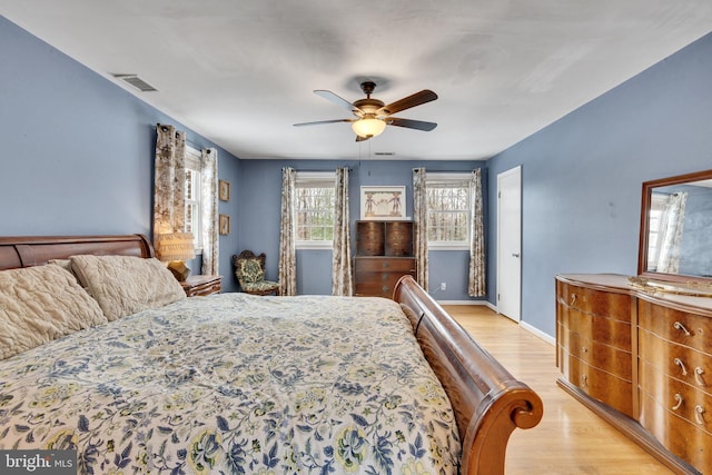 bedroom with light hardwood / wood-style flooring and ceiling fan