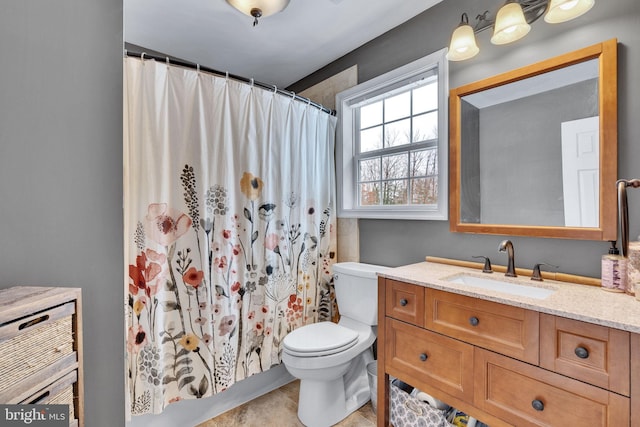 bathroom featuring vanity, curtained shower, and toilet