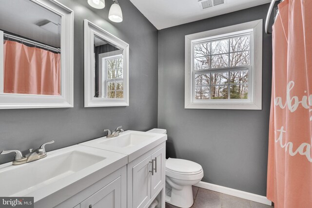 bathroom featuring tile patterned flooring, vanity, and toilet