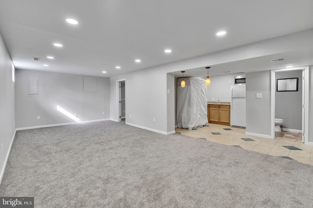 unfurnished living room with light colored carpet