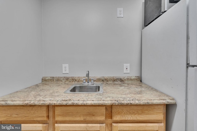 room details featuring sink and white refrigerator