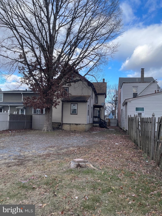 back of house featuring fence