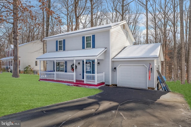 view of front of home featuring a porch, a front yard, and a garage