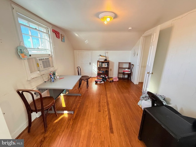 interior space with hardwood / wood-style flooring and lofted ceiling